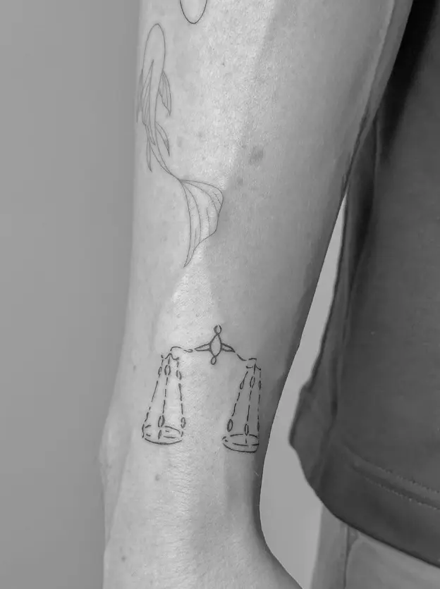 Libra scales tattoo with fine line precision by Chelsea.Q at Omnia Tattoo Studio